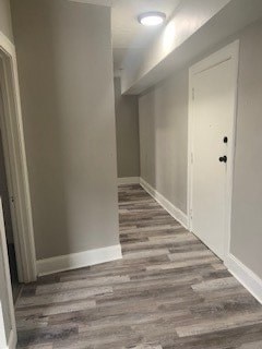 A long hallway with a grey floor and white walls.