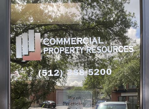 a window with the commerical property resources logo on it