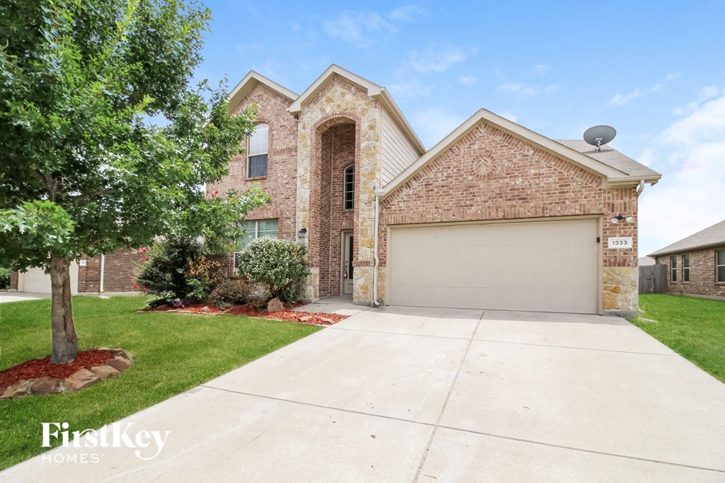 a large brick house with a white garage door