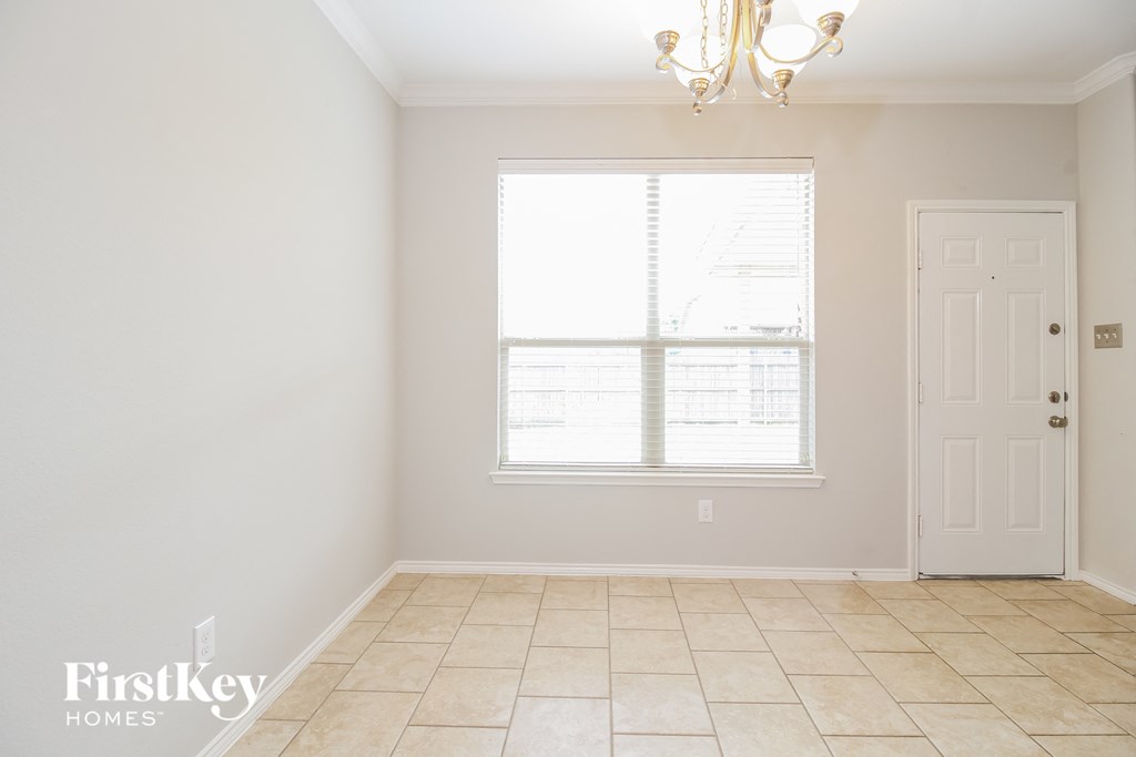 a living room with a window and a door and a tiled floor