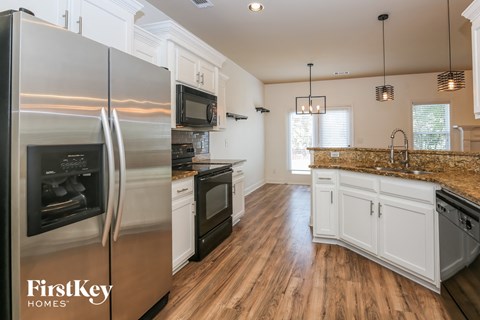 a kitchen with stainless steel appliances and white cabinets