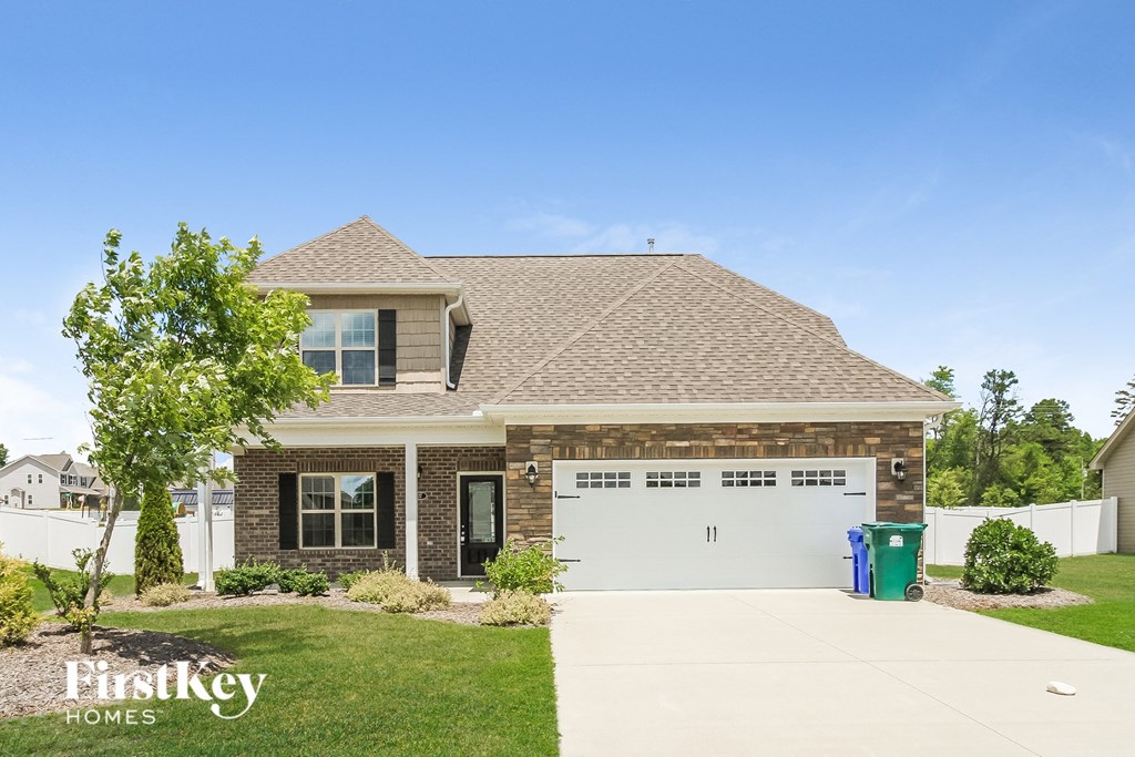 a brick house with a garage and a driveway