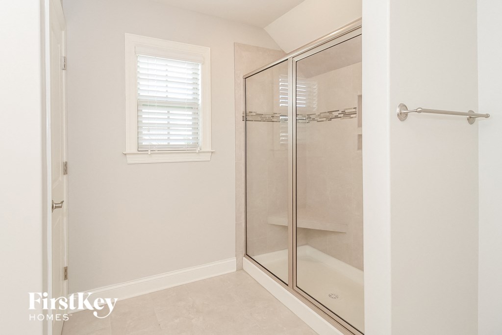 a small bathroom with a shower and a window