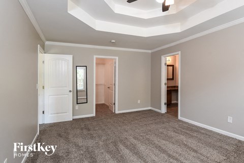 a bedroom with a carpeted floor and a white closet
