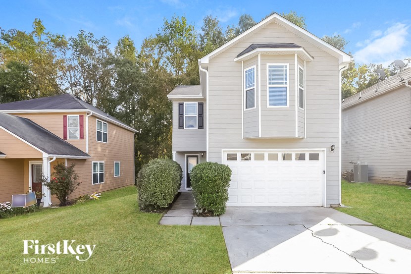 A two-story house with a garage is for sale by FirstKey Homes.