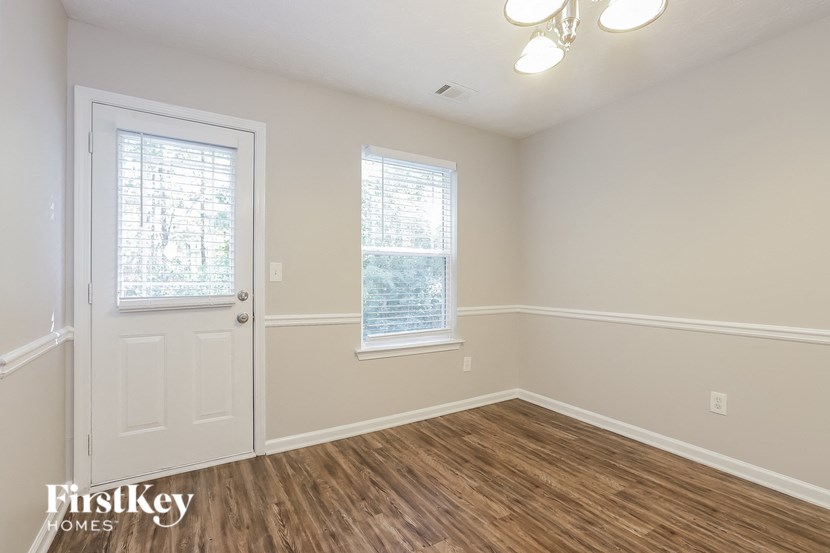 A room with a wooden floor and a white door.