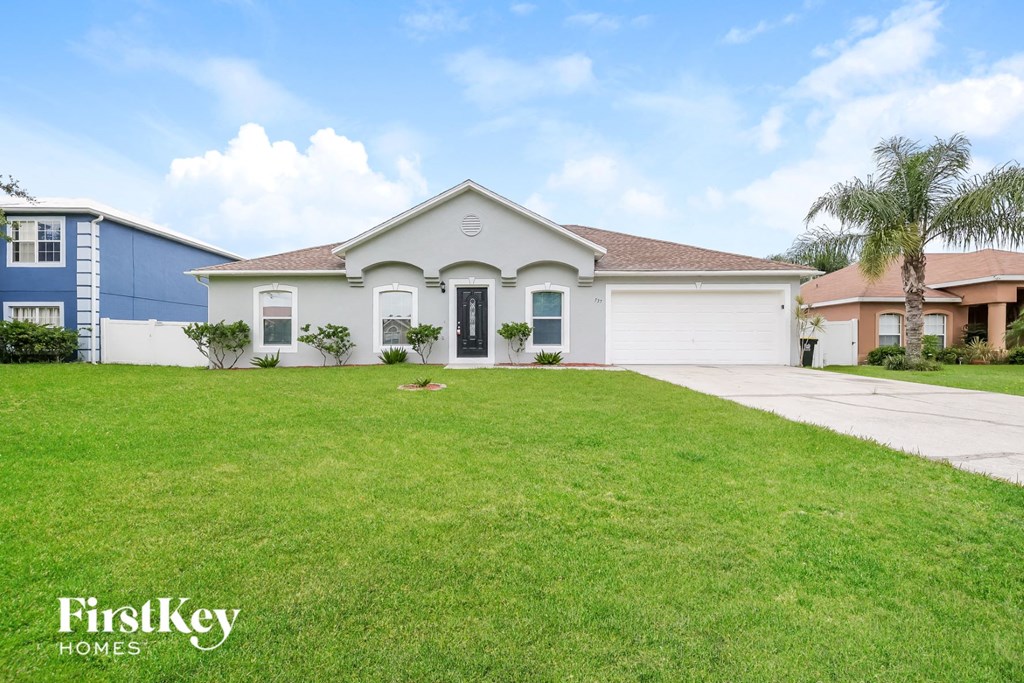 a white house with a lawn in front of it