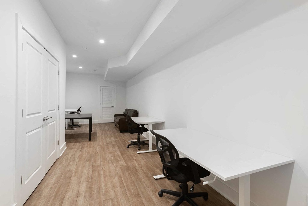 a room with desks and chairs and a door