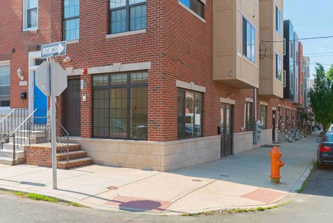 a building on the corner of a street with a fire hydrant