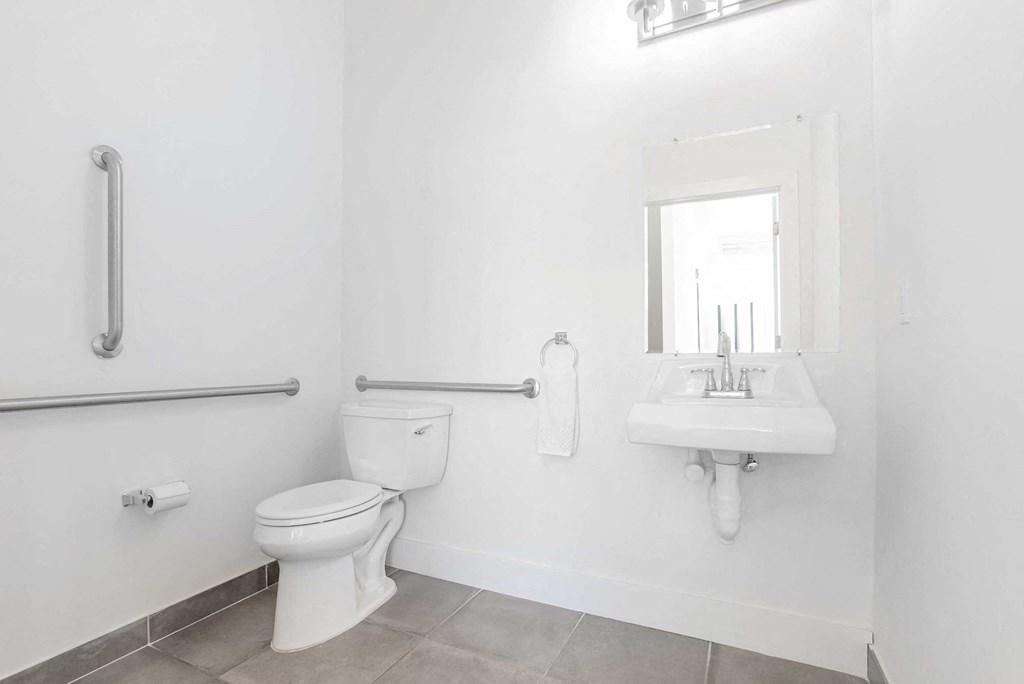 a bathroom with a toilet and a sink and a mirror