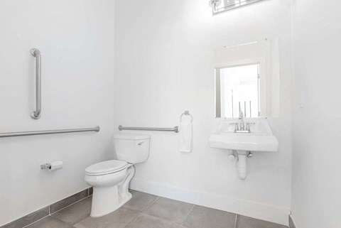 a bathroom with a toilet and a sink and a mirror