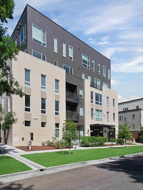 A modern building with a mix of brick and panel facades.