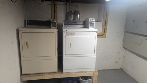 Two white appliances on a shelf in a room.