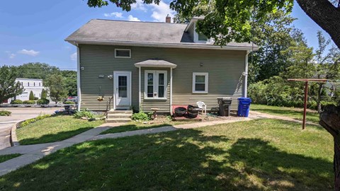 a small house with a lawn and a driveway