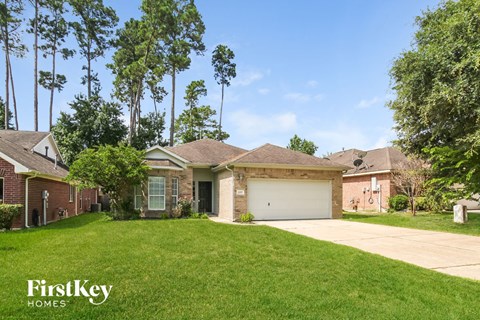a home with a lawn and a garage