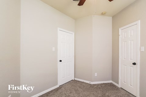 a bedroom with two closets and two doors
