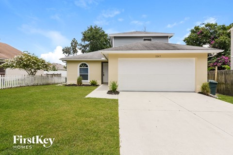 A house with a garage is for sale by FirstKey Homes.