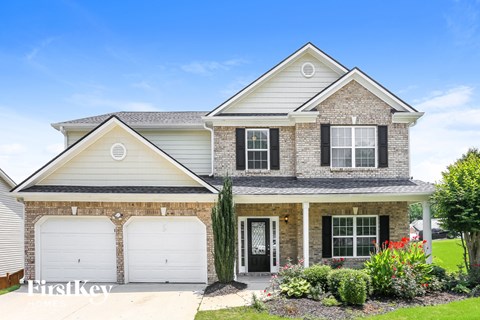 a house with two garage doors in front of it