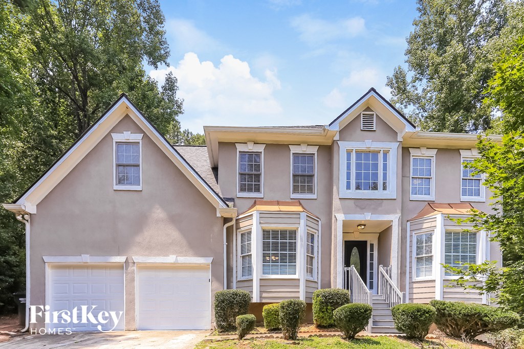 A two-story house with a garage is for sale.