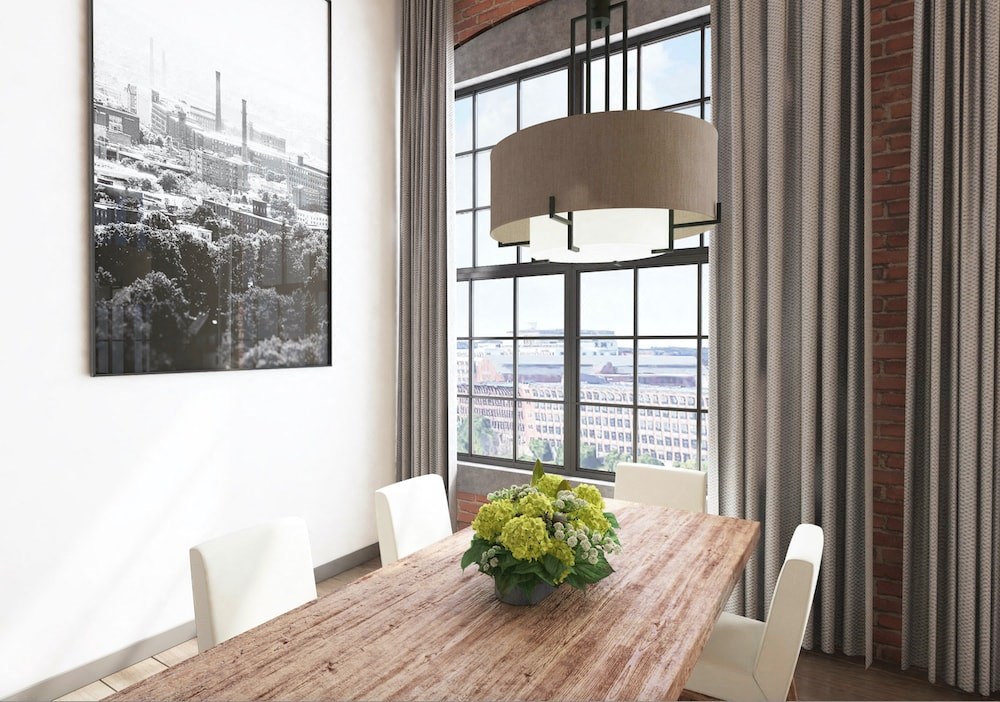 a dining room with large windows and a wooden table