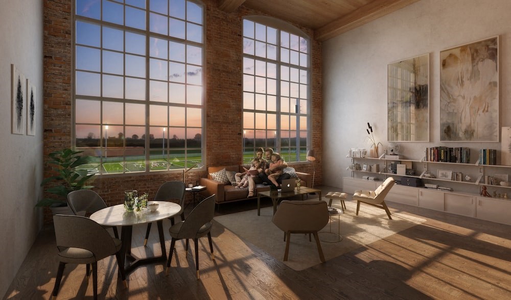 a couple sitting on a couch in a living room with large windows
