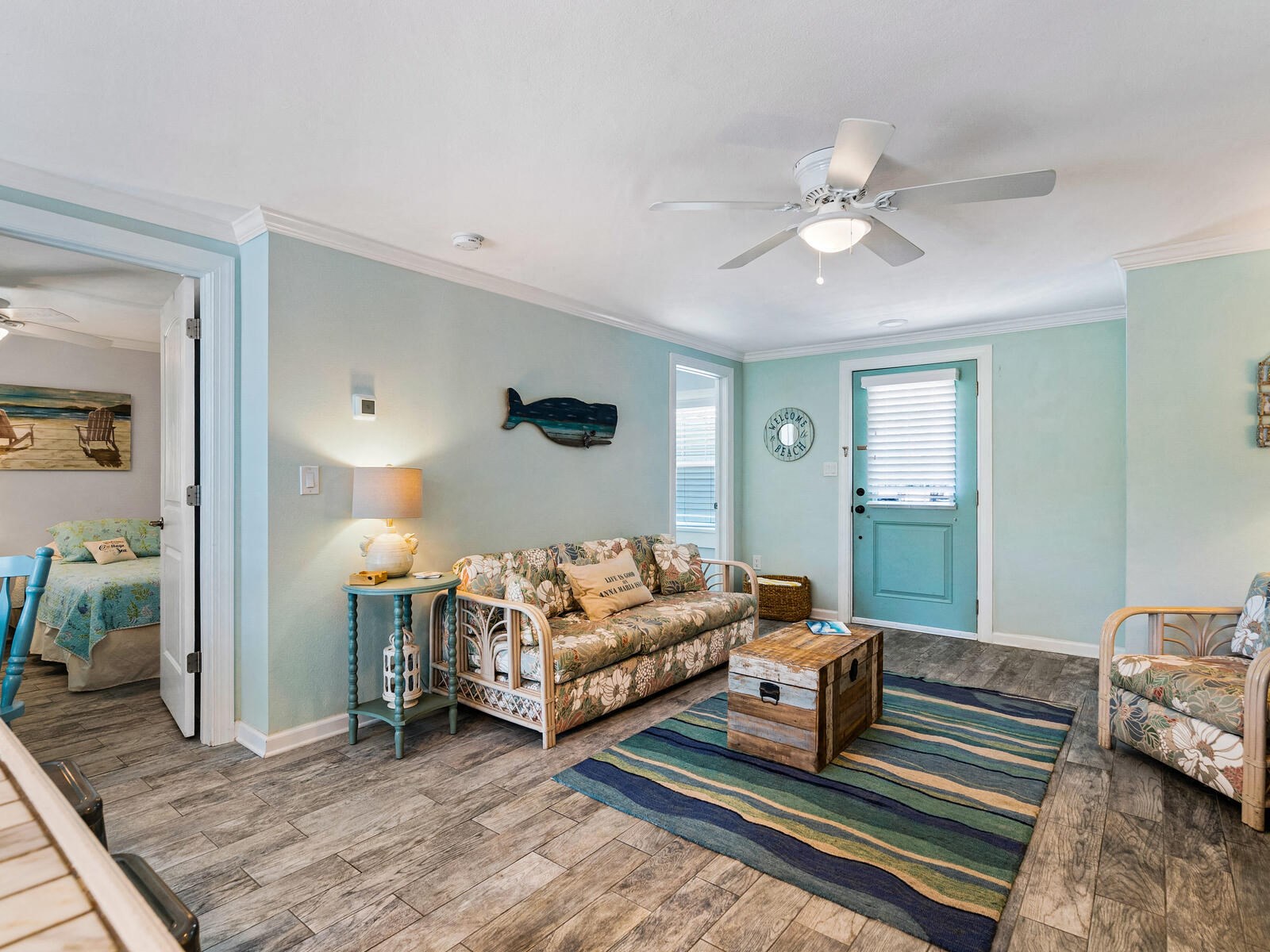 a living room with furniture and a ceiling fan