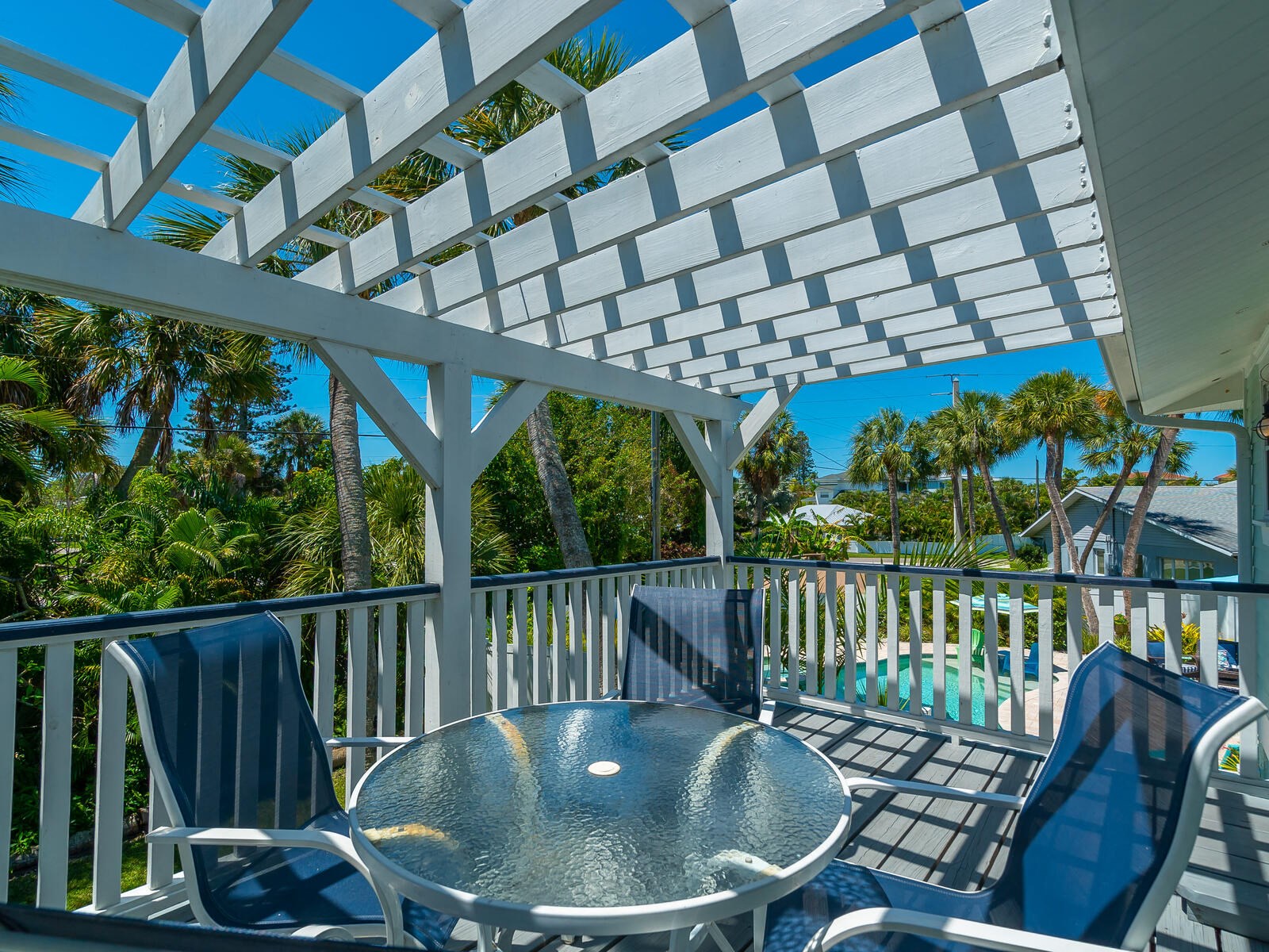 a patio with a table and chairs and a pool