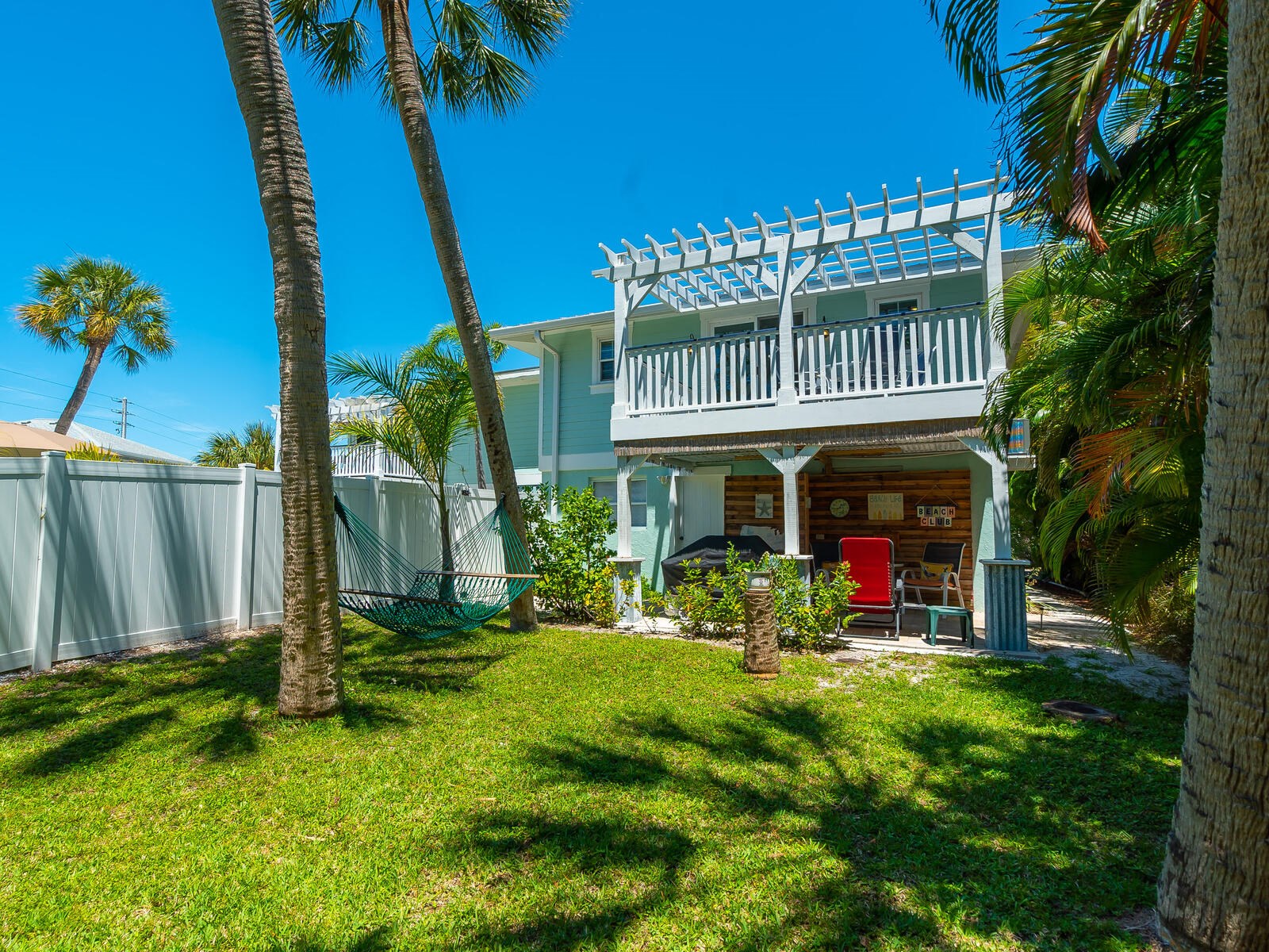 the front of the house with palm trees