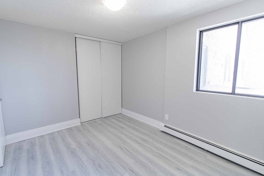 an empty room with white walls and a window