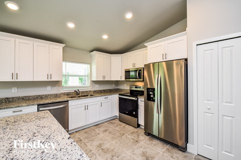 the kitchen is updated with stainless steel appliances and granite counter tops