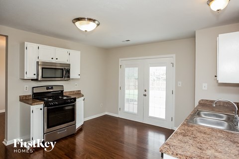 A kitchen with a microwave and oven built into the cabinetry.