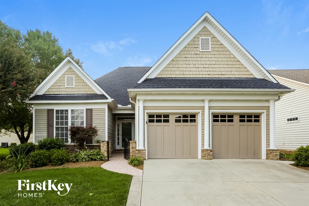 a house with two garage doors and a driveway