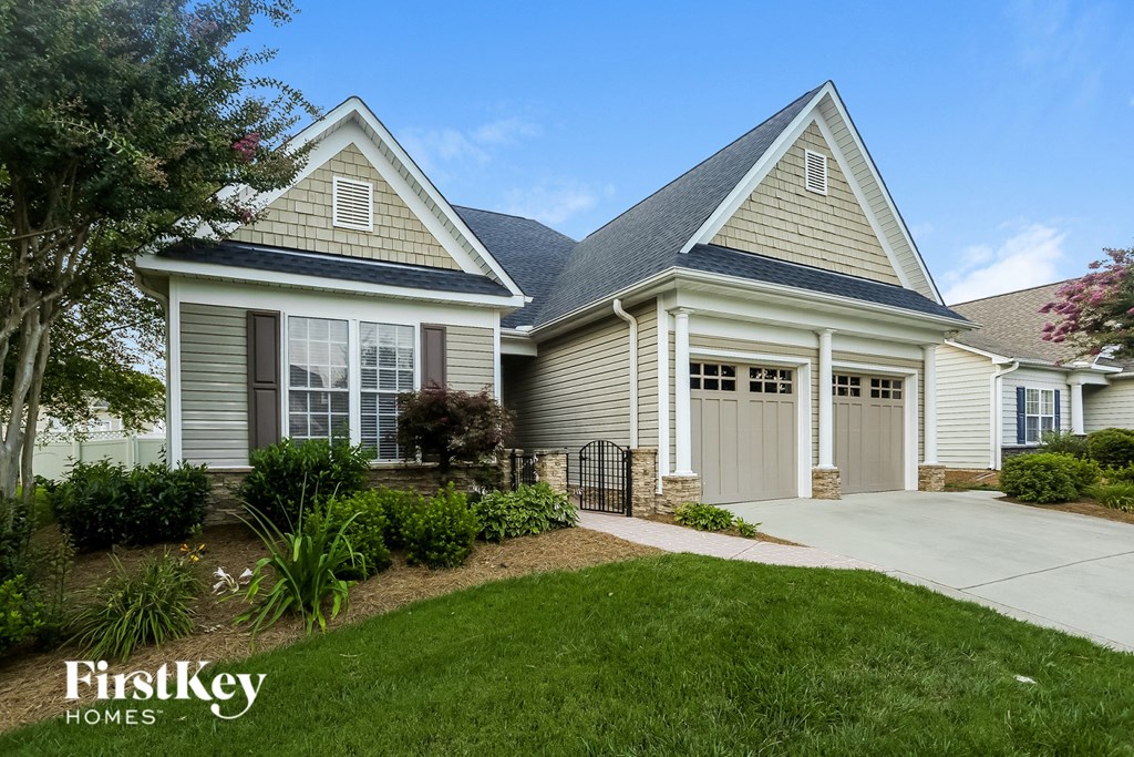 a white and gray house with a garage and a driveway