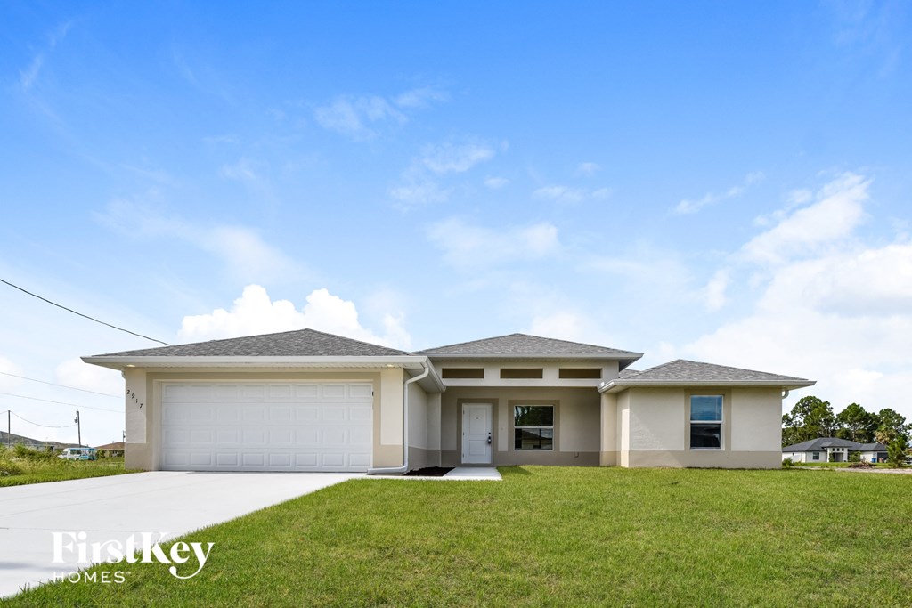 a house with a garage door and a lawn