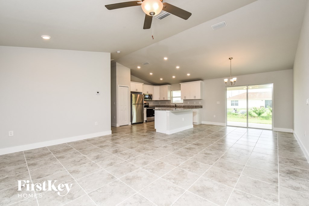 a kitchen and living room with a ceiling fan