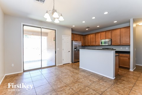A kitchen with a white counter and brown cabinets.