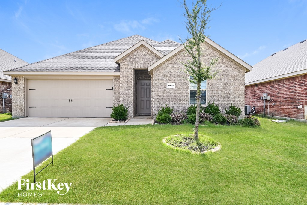 A brick house with a sign that says FirstKey Homes.