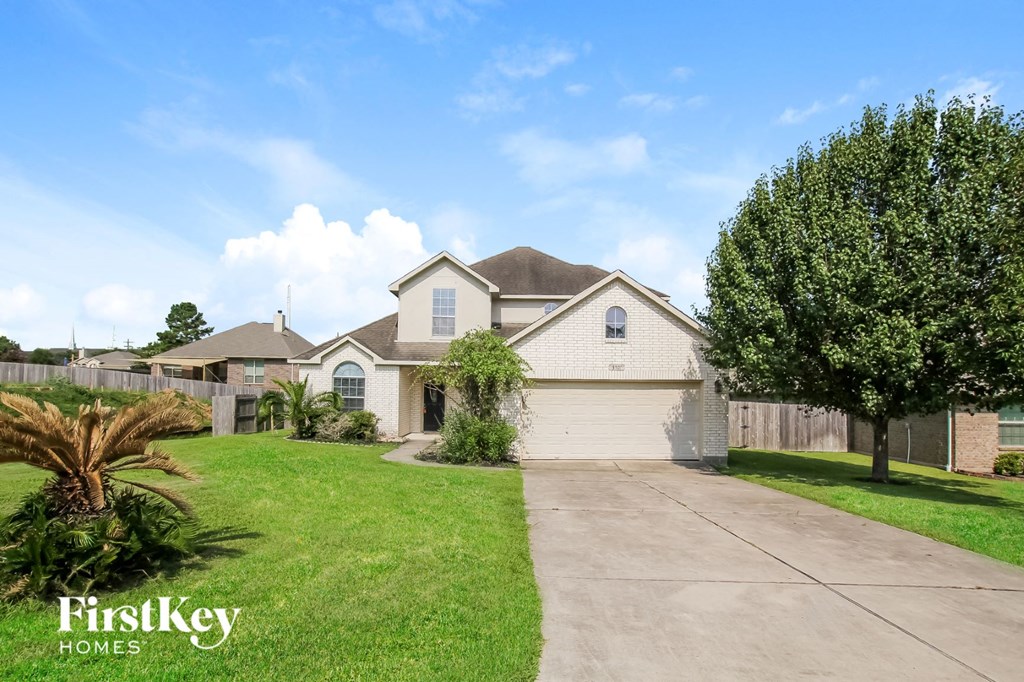 A house with a driveway in front of it.