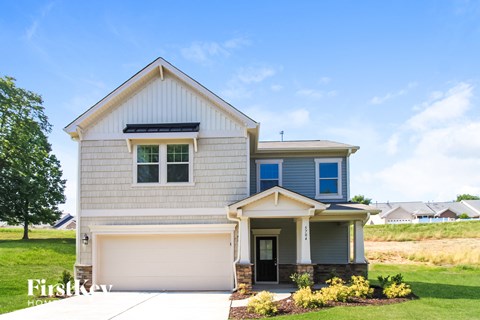 A house with a blue stripe on the side and a garage door.