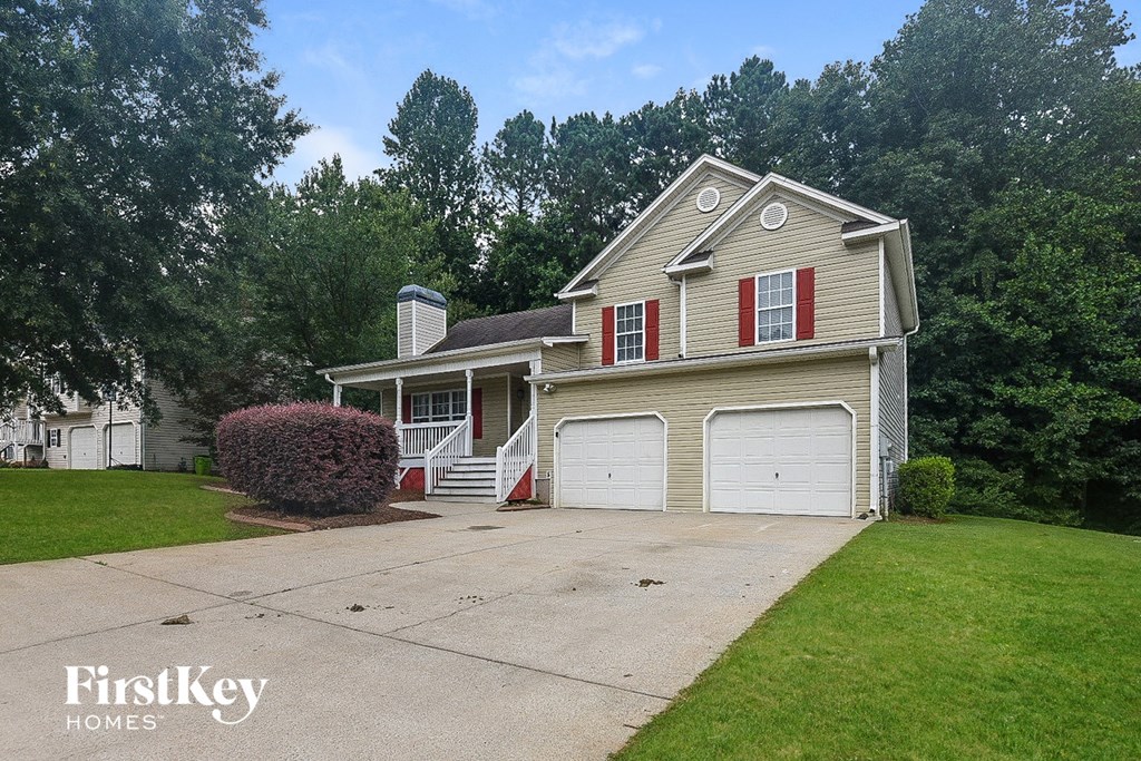 A two-story house with a garage and a chimney.