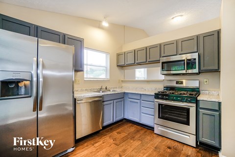 a kitchen with stainless steel appliances and blue cabinets