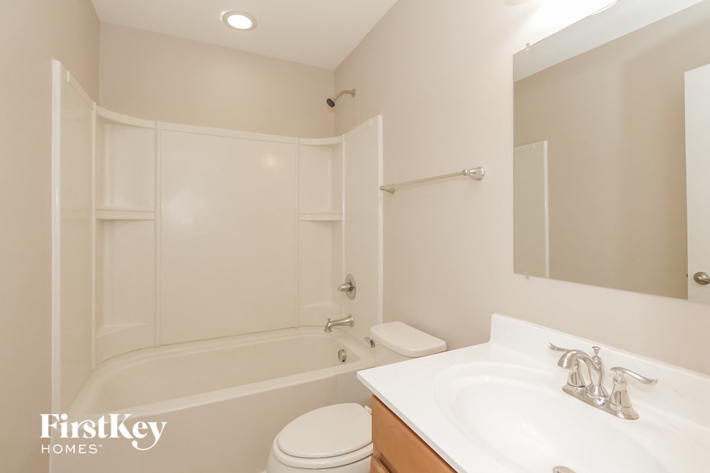 a bathroom with a sink and a tub and a toilet