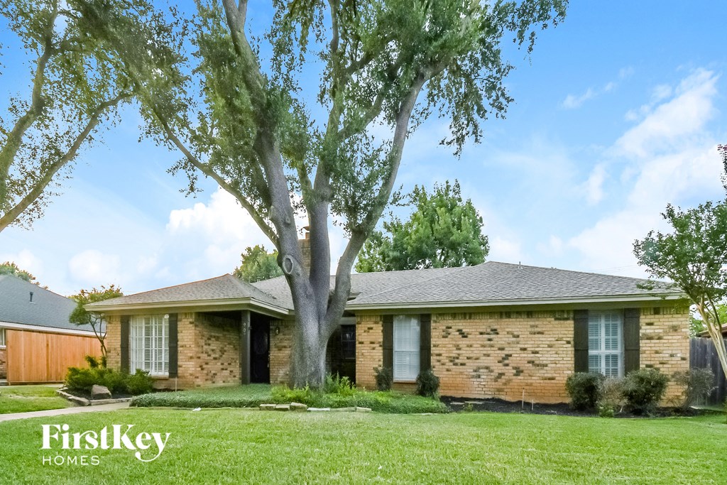 a brick house with a tree in front of it