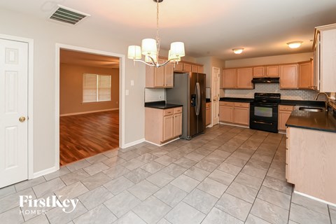 a kitchen with wooden cabinets and black appliances