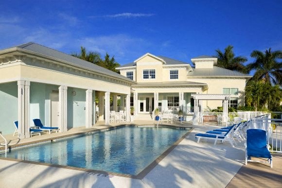 a large swimming pool in front of a house