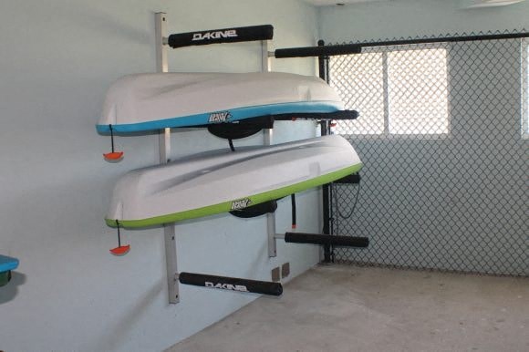 two surfboards hanging on a wall in a room