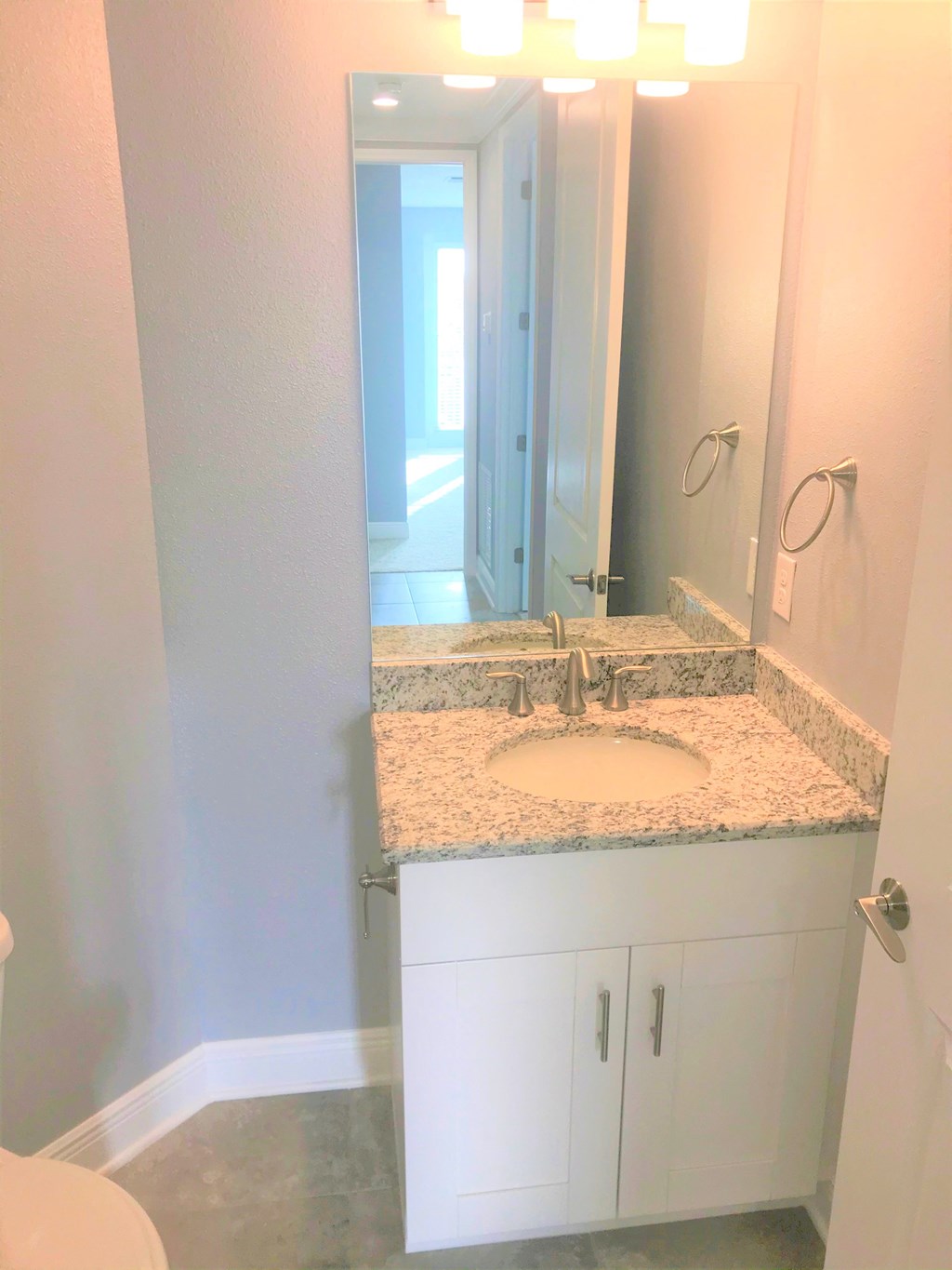 a bathroom with a sink and a large mirror