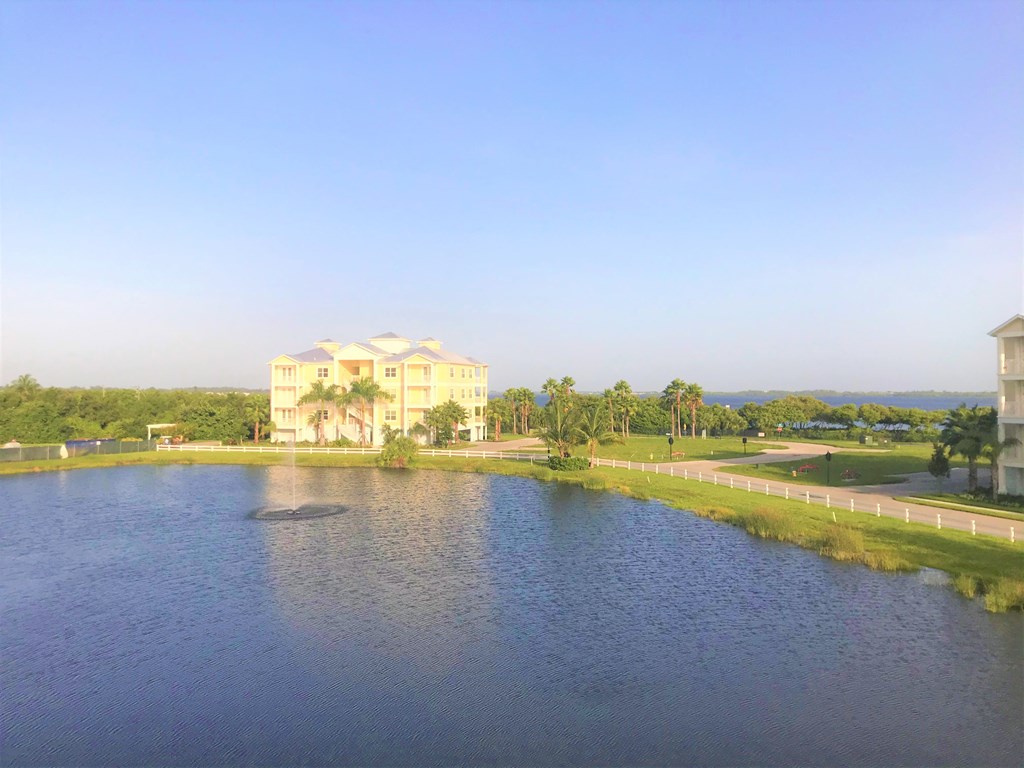an aerial view of a lake with a building in the background