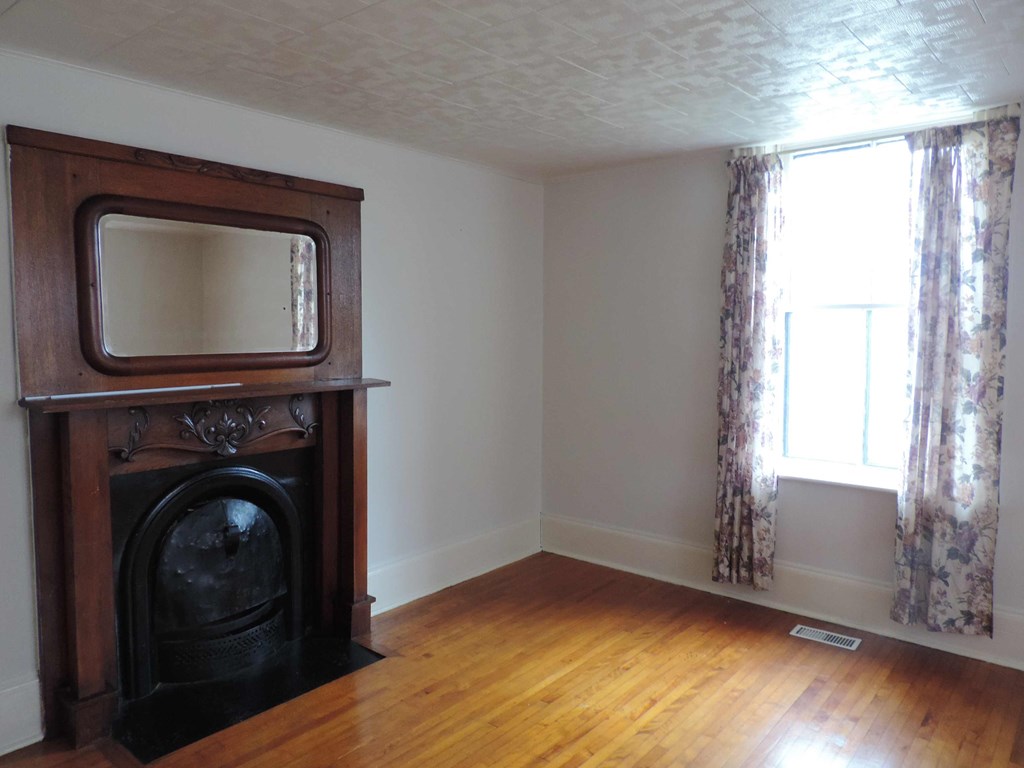 a living room with a fireplace and a tv in it
