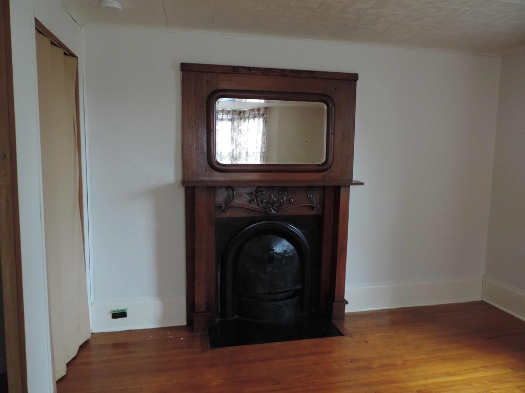 a fireplace in a living room with a tv on top of it